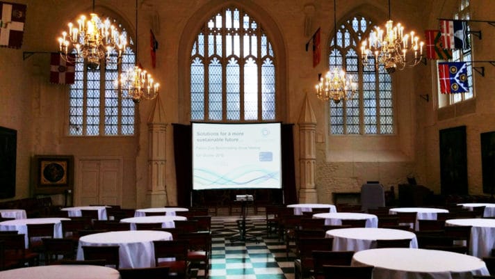 ALT="tables and chairs set up in Church to face projector and screen in front of altar"