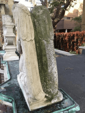 Detail of angel wings on the crucifixion statue, showing the effects of steam cleaning on organic staining