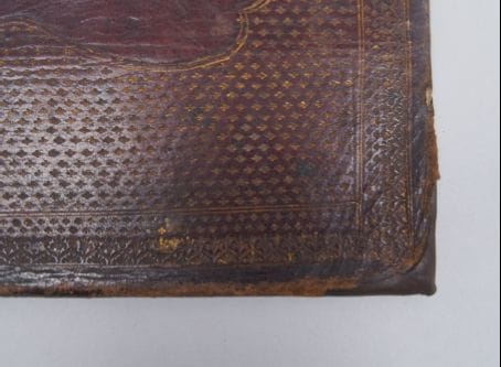 After treatment - the leather bindings now cover the boards beneath at the damaged corners.