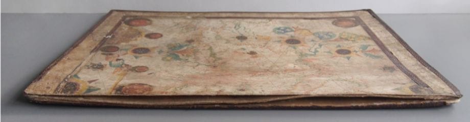 Before treatment - The raw edge of the 'spine' shows where the boards and chart have warped and split. 