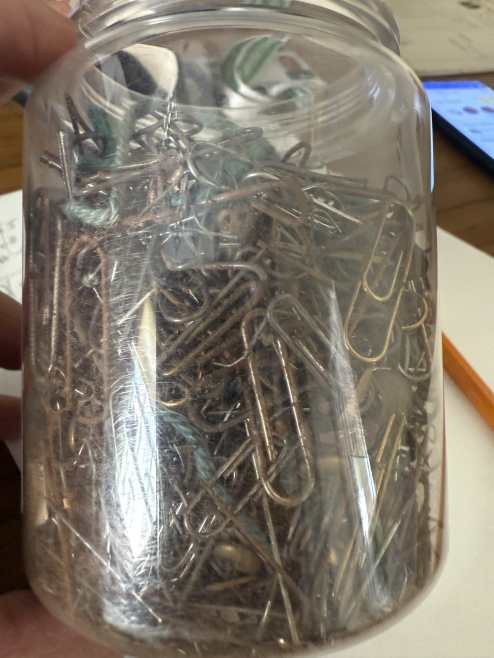Old rusty paperclips and metal fastenings removed from archival records.